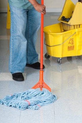 CKS Cleaning Services, Inc. janitor in Double Shoals, NC mopping floor.
